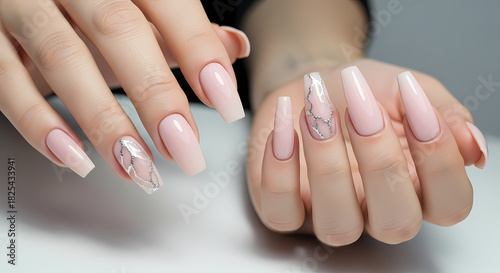 Elegant light pink coffin nails with glitter and rhinestone accents on two hands