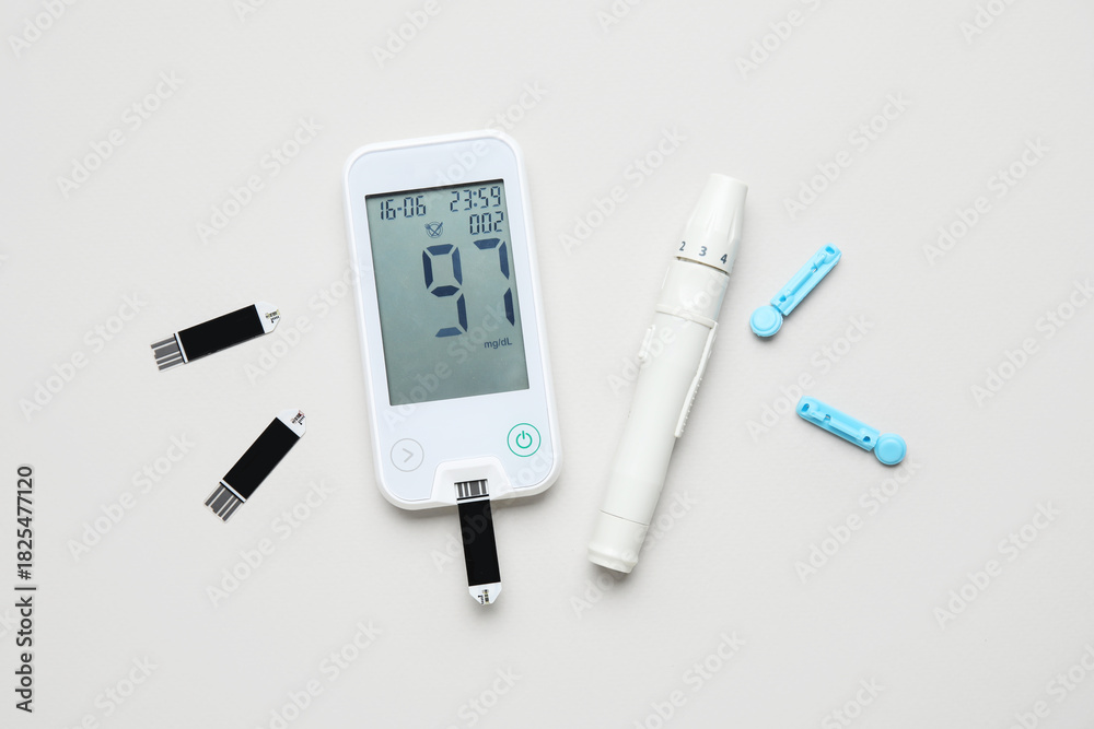 Fototapeta premium Glucometer, lancet pen, test strips and disposable needles on grey background. Diabetes concept