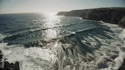 Dramatic Coastal Waves Crashing Against Cliffs on a Sunny Day.