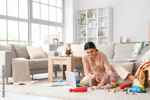 Young business mother worki...
