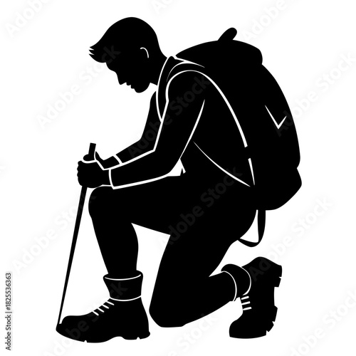 Silhouette of a hiker kneeling with a backpack and trekking pole