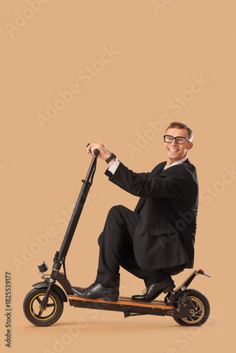 Young businessman riding el...