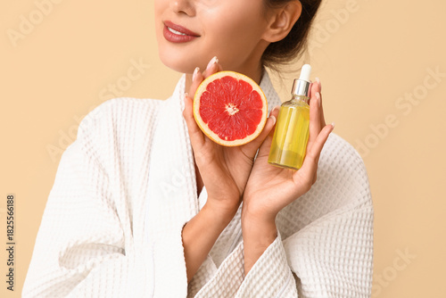 Young woman in bathrobe hol...