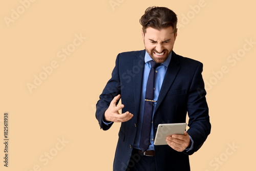Angry businessman with tabl...