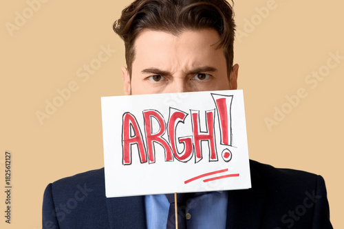 Canvas Print Angry businessman with paper sign on beige background, closeup