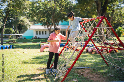 Children Playing on Outdoor Playground Equipment During Daytime, Engaging in Physical Activity and Developing Social Skills in Natural Environment