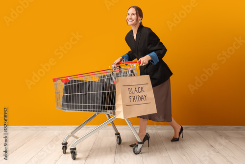 Happy woman pushing shoppin...