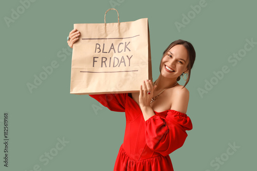 Happy young woman holding s...
