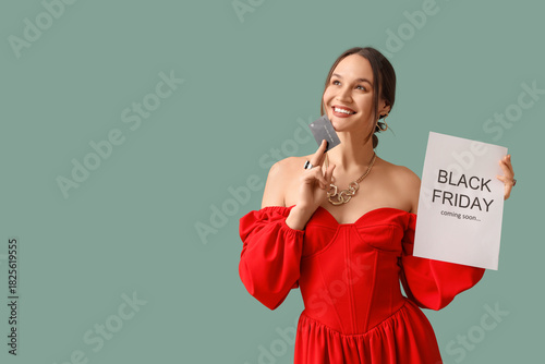 Happy young woman holding p...