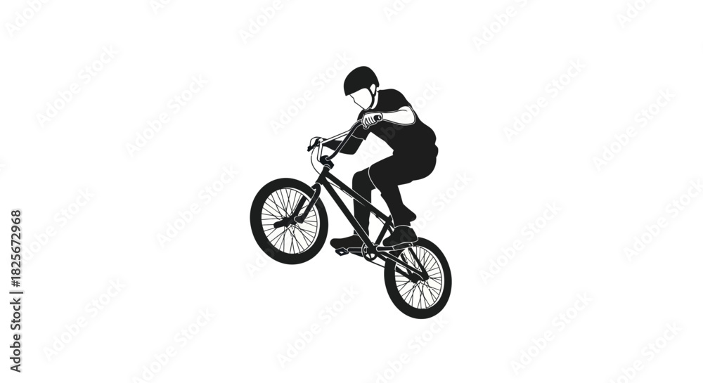 Fototapeta premium Silhouette of BMX Rider Performing a Wheelie Trick.