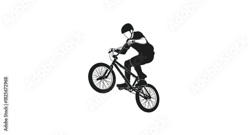 Silhouette of BMX Rider Performing a Wheelie Trick.