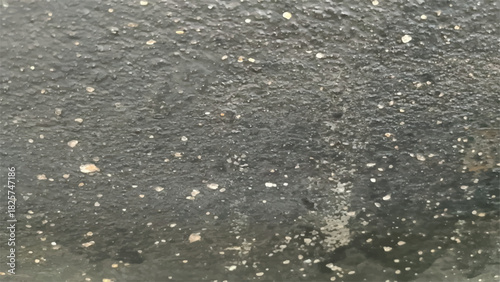 Abstract black and gray asphalt road surface closeup with white line and texture of rain water drops