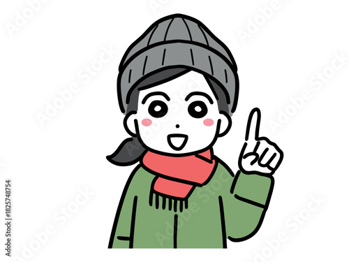 笑顔で指差しポーズをしているマフラーを巻いた冬服の若い女性(上半身・正面)