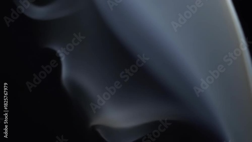 Ethereal smoke patterns swirling gracefully against a dark backdrop