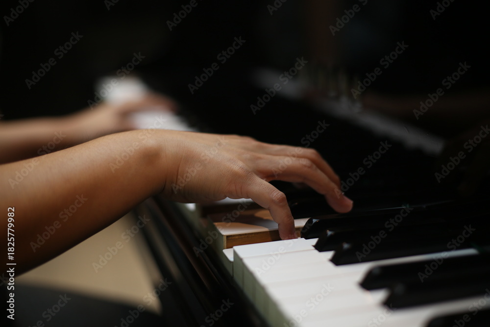 Fototapeta premium Close-Up of Hands Playing grand piano Keys Music Practice and Performance Concept