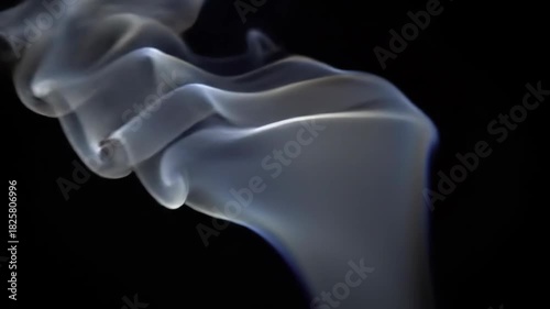 Ethereal smoke swirling gracefully against a dark background, creating a mesmerizing visual effect