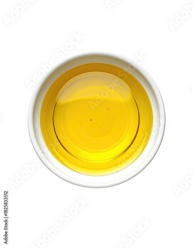 Golden liquid in a white bowl, overhead angle, simple