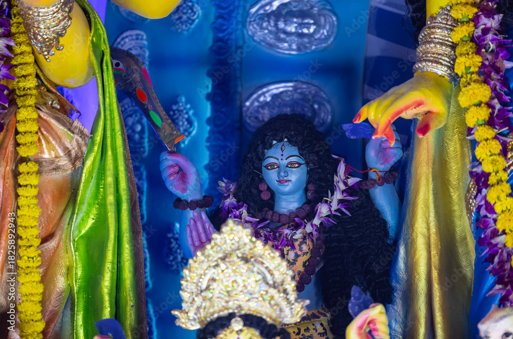 Fototapeta premium A beautifully crafted handmade colorful goddess durga idol decorated for Navratri, featuring vibrant traditional attire, intricate jewellery, and divine expressions at colorful pandal.