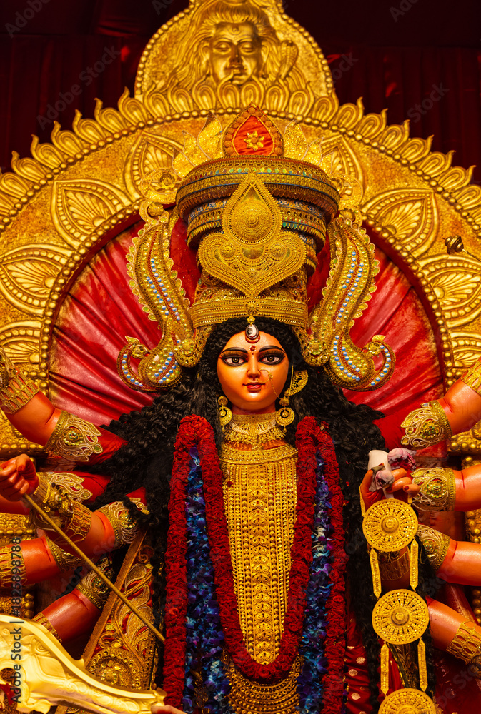 Fototapeta premium A beautifully crafted handmade colorful goddess durga idol decorated for Navratri, featuring vibrant traditional attire, intricate jewellery, and divine expressions at colorful pandal.
