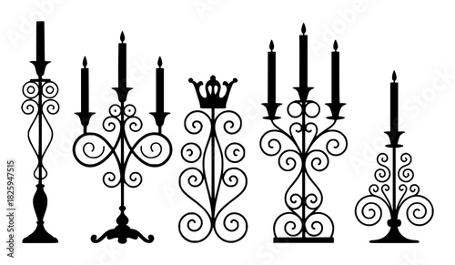 Collection of ornate black silhouette candle holders with candles