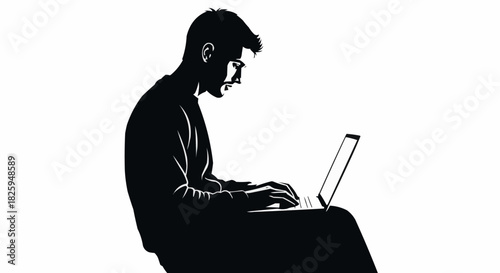 Silhouette of a man working on a laptop computer, focused and concentrated.