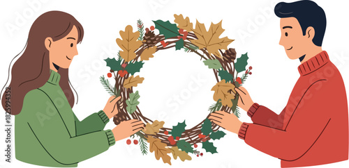 Two people, a man and a woman, are making a fall wreath together, using foliage and pinecones.
