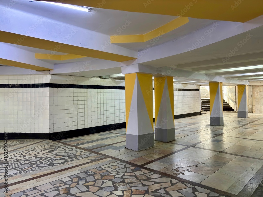 Fototapeta premium Vintage underground passage with geometric yellow & gray support beams