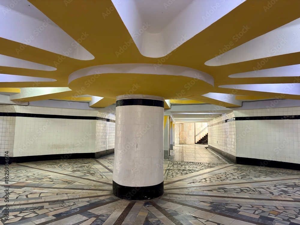 Fototapeta premium Underground passage with radial beams, geometric mosaic floor