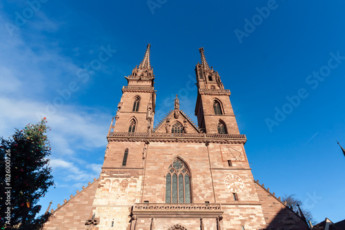Close-up of the impressive red sandstone facade and twin Gothic spires of the Basel Minster cathedral