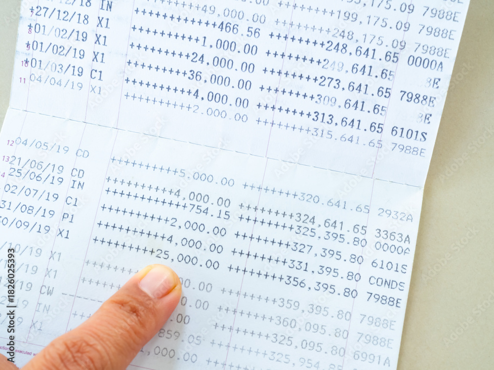 Obraz premium Bank account book statement balance number cash, hand holding data investment debt math in office, bill receipt and payment business credit card account, check paper financial loan tax concept.