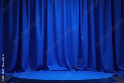 Intense cobalt blue stage drape, sharp creases, shadow, sharp