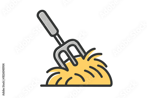 Classic farming tool pitchfork stuck into a large mound of yellow straw or dry hay