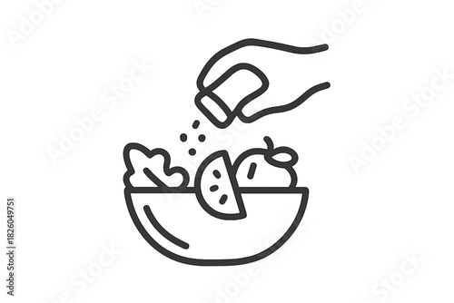 Hand sprinkling seasoning from a shaker onto a fresh salad bowl with vegetables and fruit