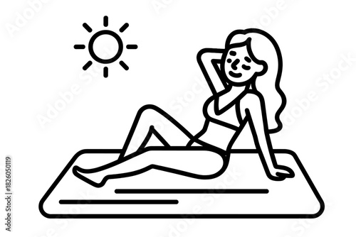 Woman relaxing on a towel or mat while sunbathing under the summer sun