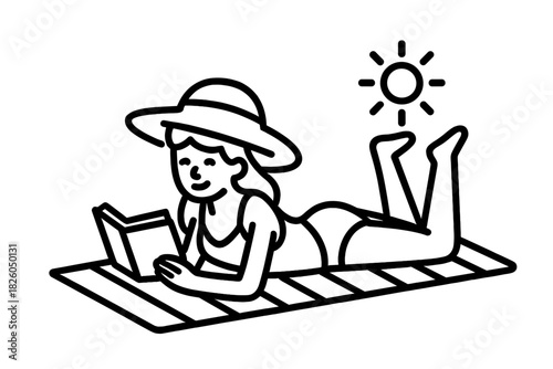 Woman reading a book and sunbathing on a beach towel during summer vacation