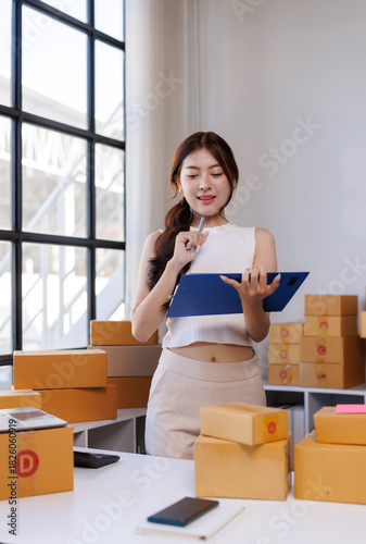 Young woman managing online store checking shipping orders