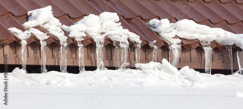 A roof covered in snow and icicles