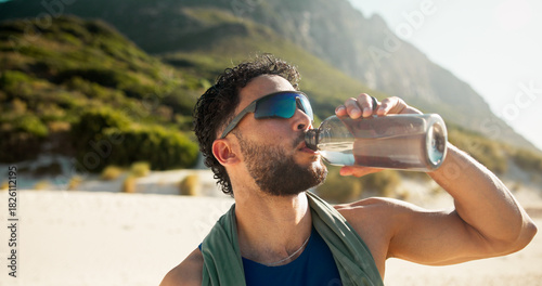 Cuadro en lienzo Fitness, break and man with drinking water by beach, hydration and sunglasses for summer training