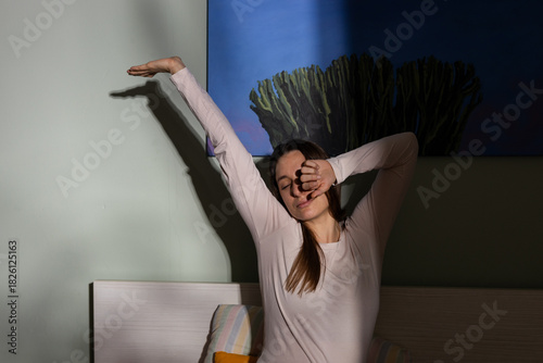 Woman waking up stretching in morning light