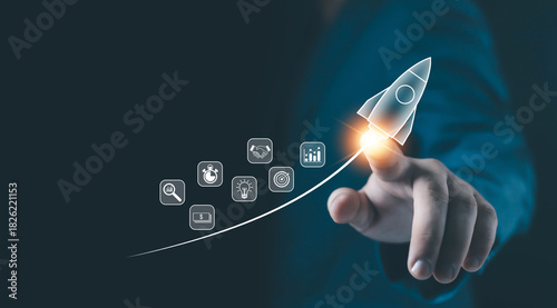 Fototapeta Naklejka Na Ścianę i Meble -  A glowing rocket icon launched from a fingertip represents startup growth, business development, innovation strategy, and digital technology progress for modern companies aiming for success.