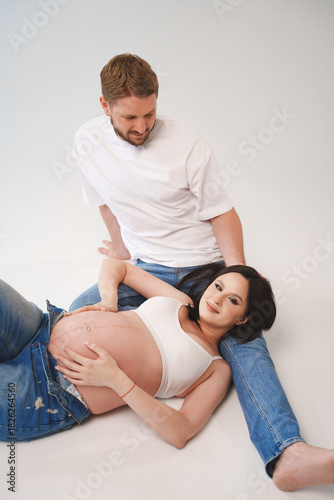Couple enjoys a joyful moment during maternity shoot
