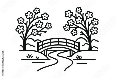 Traditional Japanese style arched bridge over a winding path between two blooming cherry trees