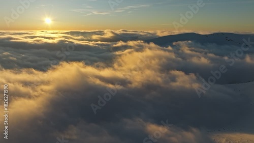 Serene sunrise bathes calm clouds and mirrored waters peacefully, Peaceful early morning scene with golden rays illuminating quiet skies and reflective surfaces