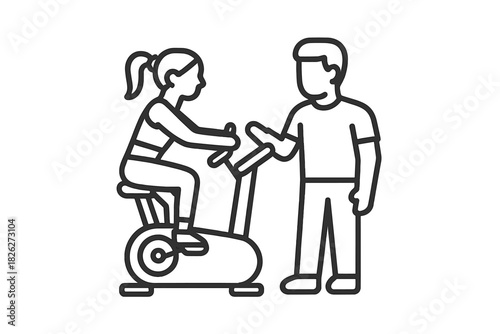 Personal fitness trainer assisting a woman exercising on a stationary spin bike at the gym
