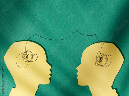 Two human silhouettes connected by a line between their heads, symbolizing empathy, emotional connection, communication, understanding, and interpersonal relationships, 