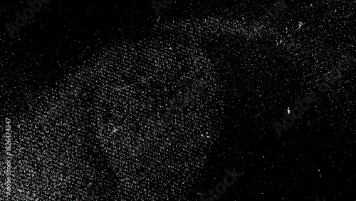 Black slow motion particles resembling snowy dust in a dark textured space, Grunge black and white scratched textured background. Abstract messy and distressed element
