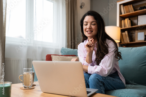 Experienced online psychotherapist guiding women through recovery after domestic abuse, offering emotional support, trauma healing, empowerment and safe space during virtual therapy session on laptop