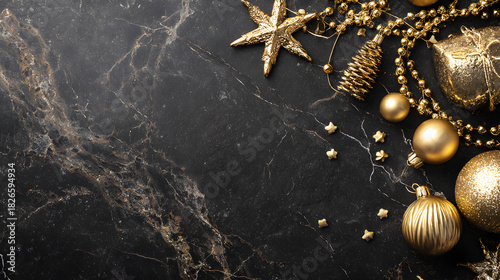 Luxurious holiday gold décor scattered stylishly around black marble background, copy space in center 
