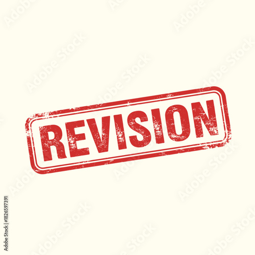 Red grunge rubber stamp with the word REVISION on a light background.