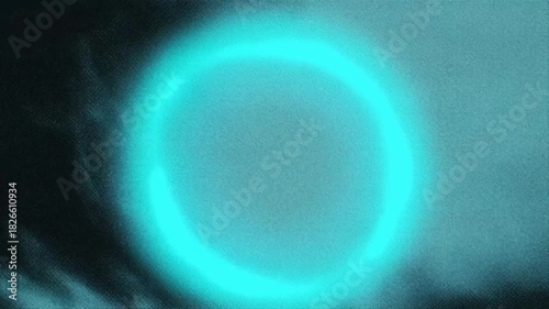 A glowing blue circle on a dark background, featuring a light halo effect.